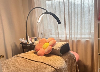Tranquil treatment room at Brows: By Hazel Bromiley, Chorley, England, GB, featuring a cozy bed and soft lighting.