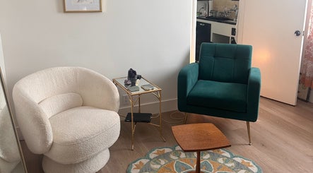 Elegant seating area at Donna Cherie Aesthetics, Santa Cruz, California. Features plush chairs and stylish decor.