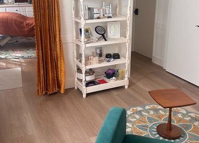 Cozy treatment room at Donna Cherie Aesthetics in Santa Cruz, California, US, with plush seating and beauty products.
