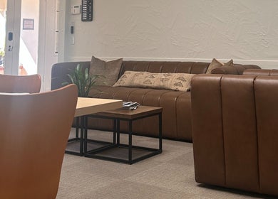 Modern lounge area at Donna Cherie Aesthetics, Santa Cruz, California, US with cozy brown seating.