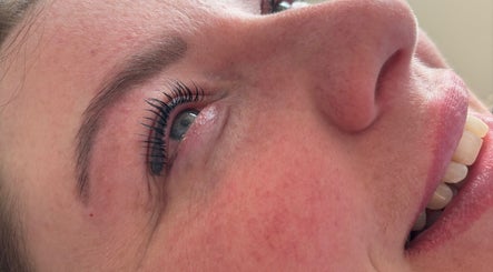 Eyelash extension close-up at _byaimeececcarelli, Bristol, England, GB showcasing natural beauty results.