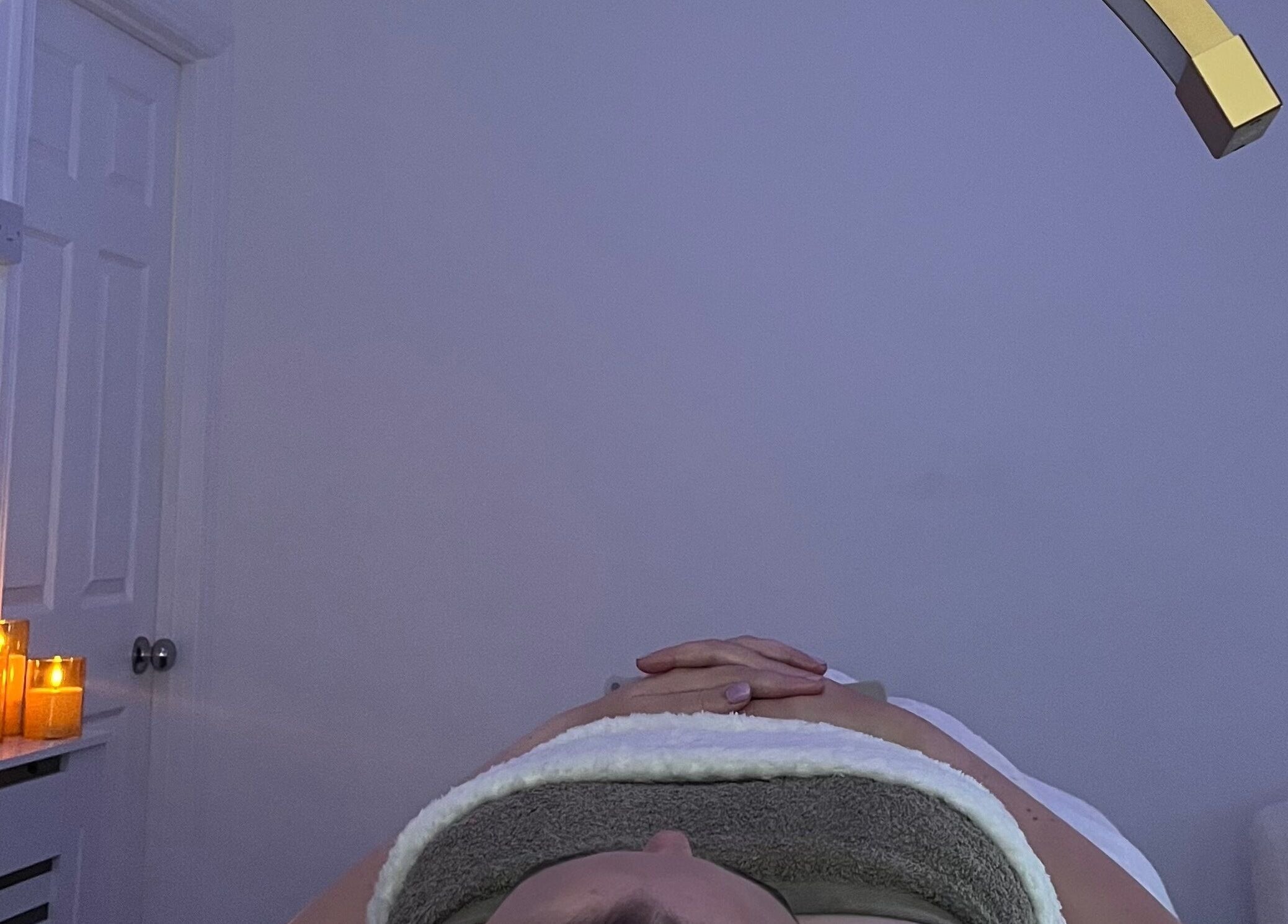 Relaxing spa ambiance at Skin Luxe Studio, Fleur-de-lis, Wales, GB with soothing candles and comfort.