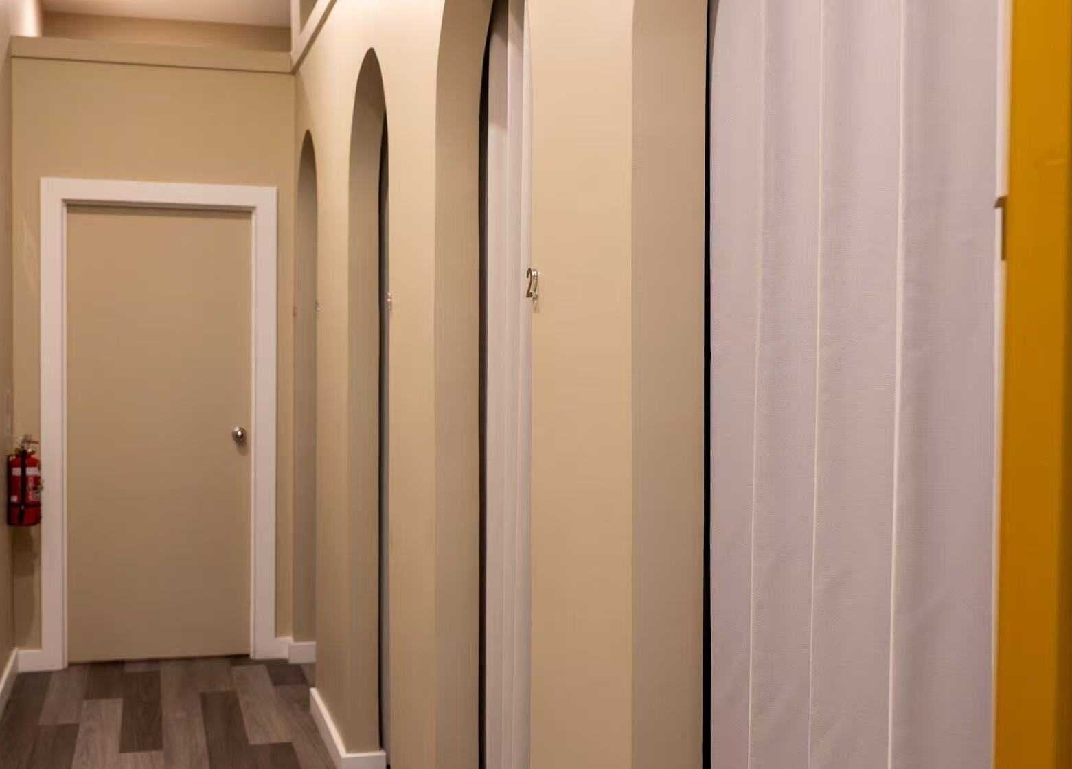 Hallway view at Cozy Time Massage, Coolangatta, Queensland, AU, featuring calming tones and private doors.