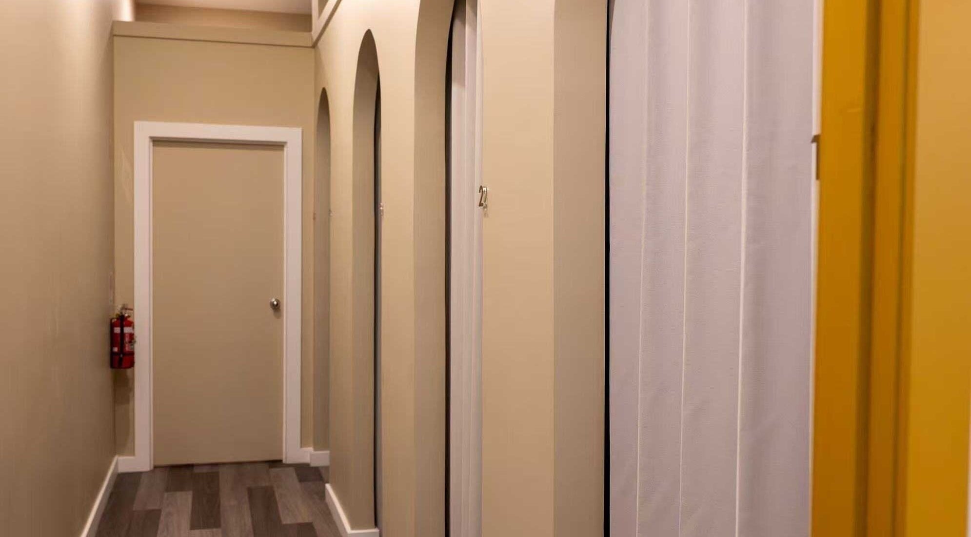 Hallway view at Cozy Time Massage, Coolangatta, Queensland, AU, featuring calming tones and private doors.