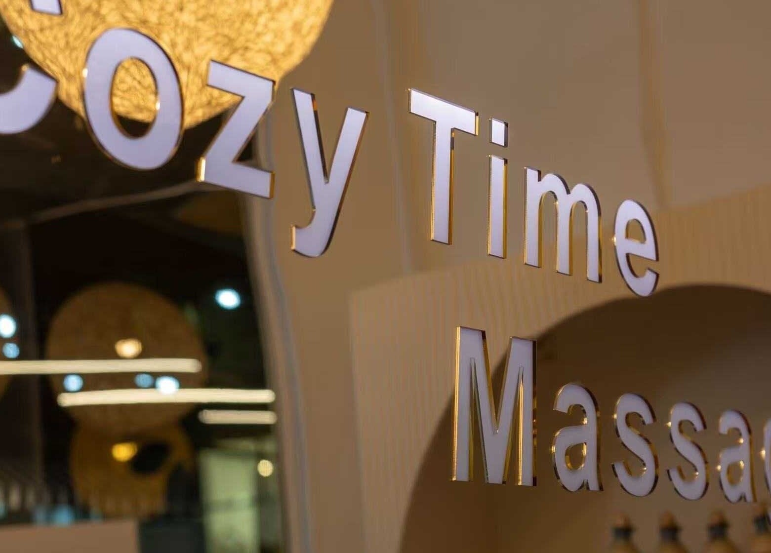 Cozy Time Massage entrance sign warmly lit in Coolangatta, Queensland, AU for a calming experience.