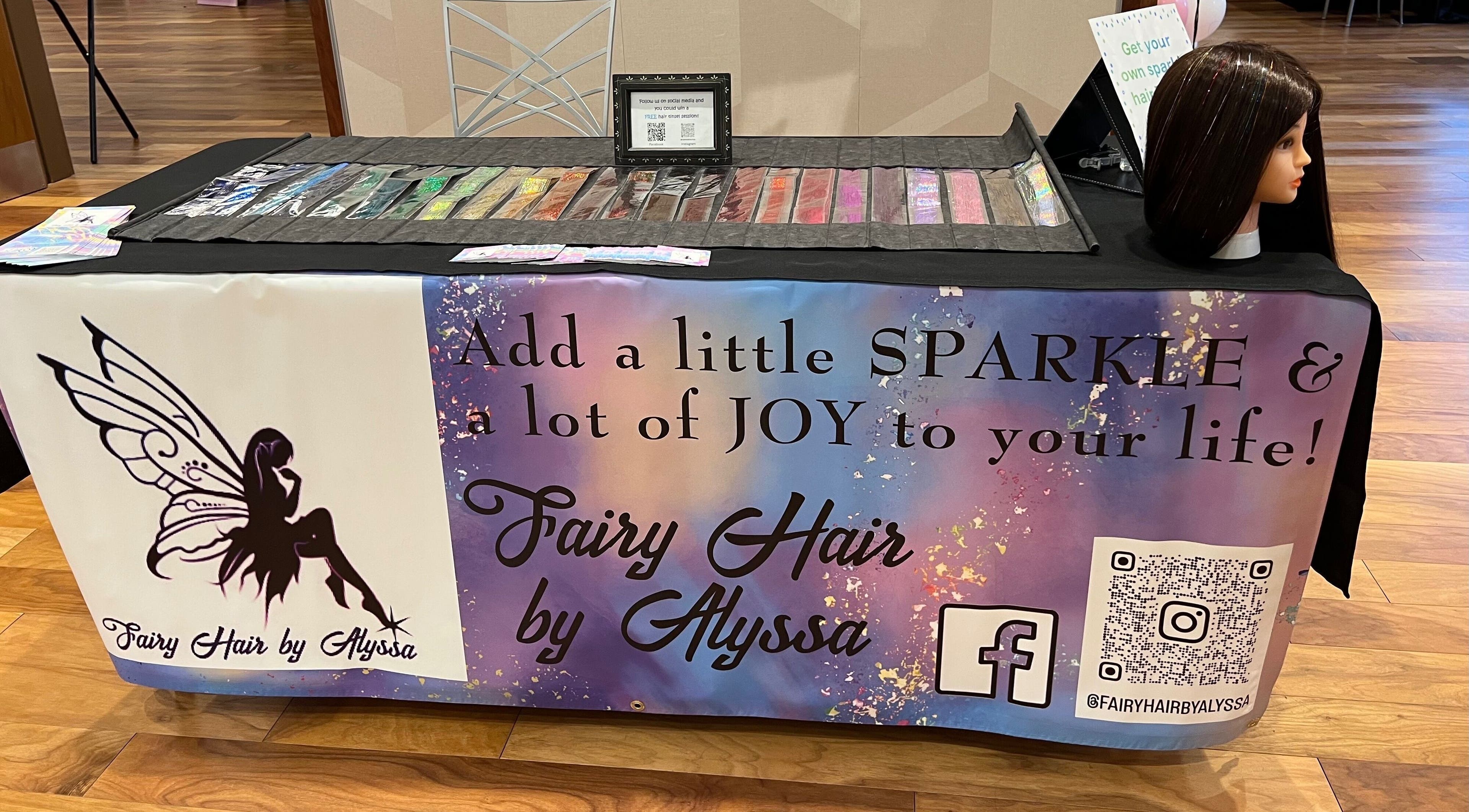 Colorful display table at Fairy Hair by Alyssa in Columbus, Ohio, US showcasing hair sparkle products.