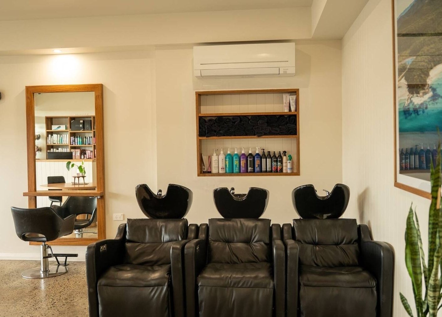 Modern interior of Beachcomber Hairsalon, Ulladulla with sleek wash stations and styling chair.