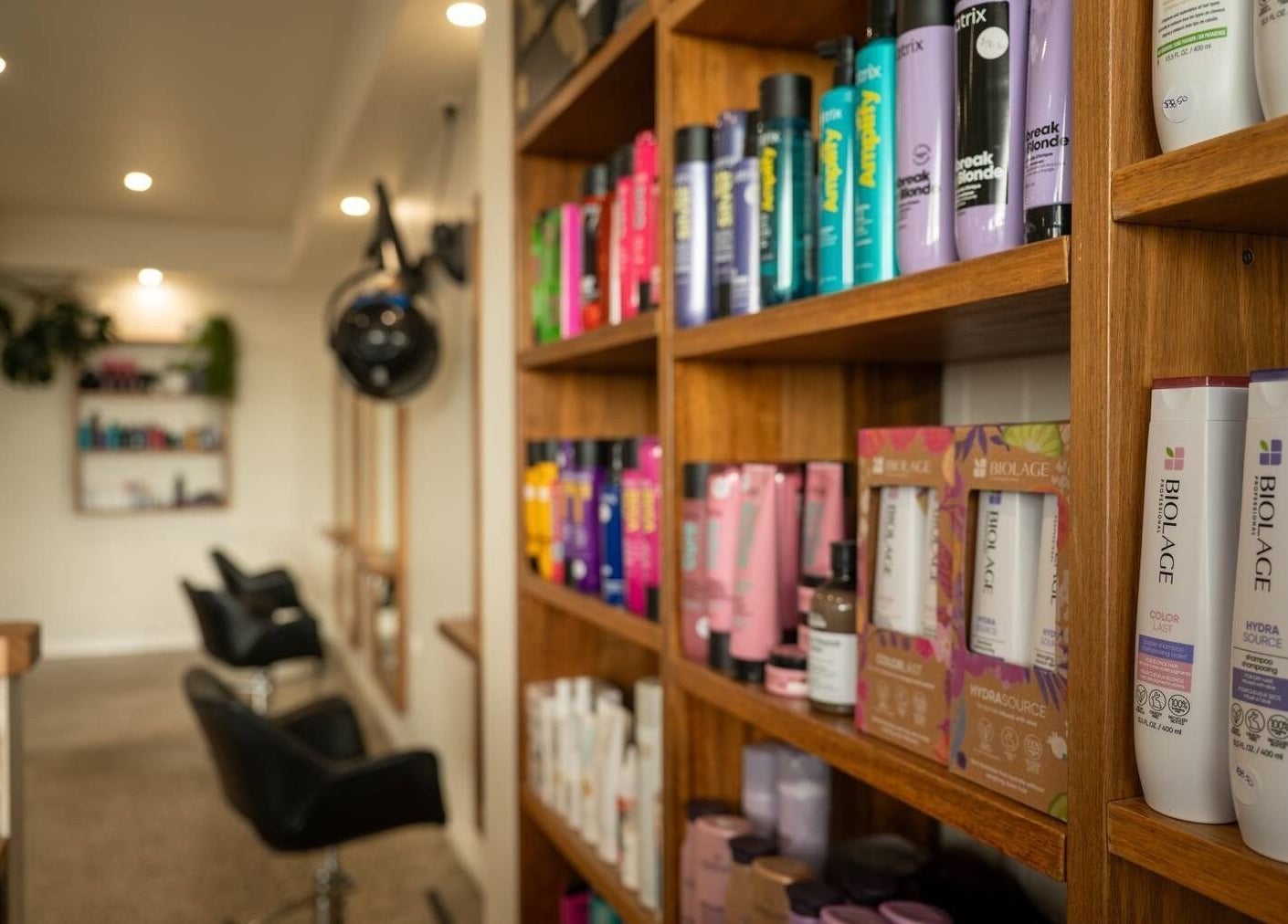 Beachcomber Hairsalon in Ulladulla, New South Wales features elegant haircare products neatly displayed on shelves.