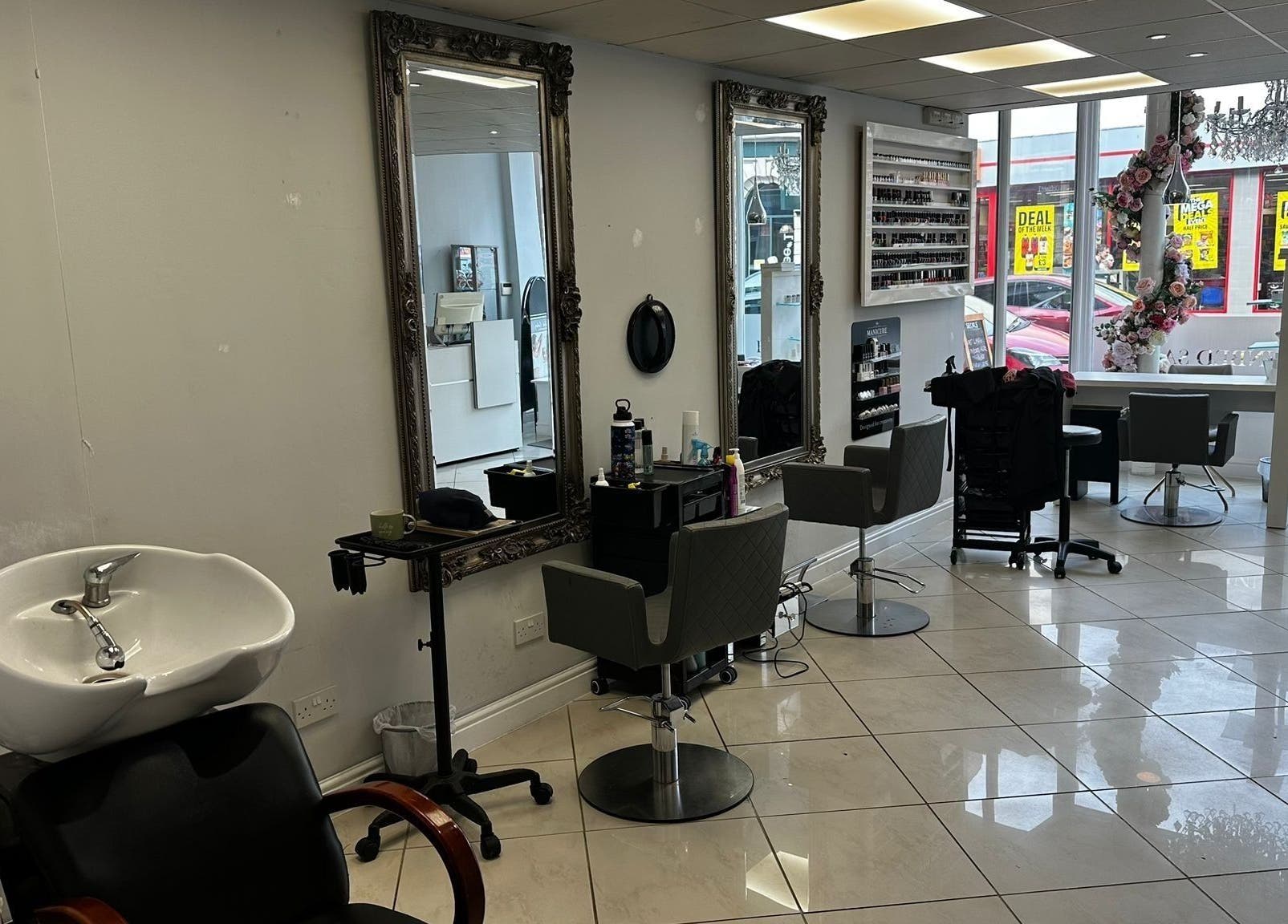 Modern salon interior at Mlinko hair in Bournemouth, England, GB with elegant chairs and mirrors.