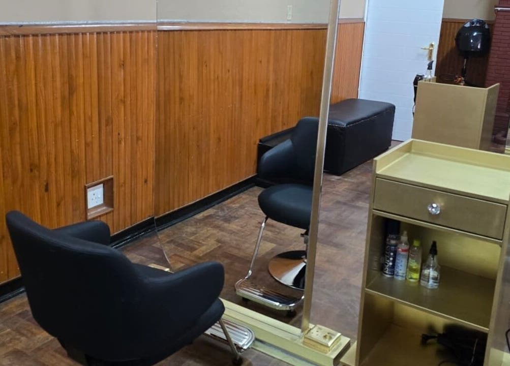 Modern salon interior at On The Edge Prostyling, Upington, Northern Cape, ZA, with sleek black chairs.