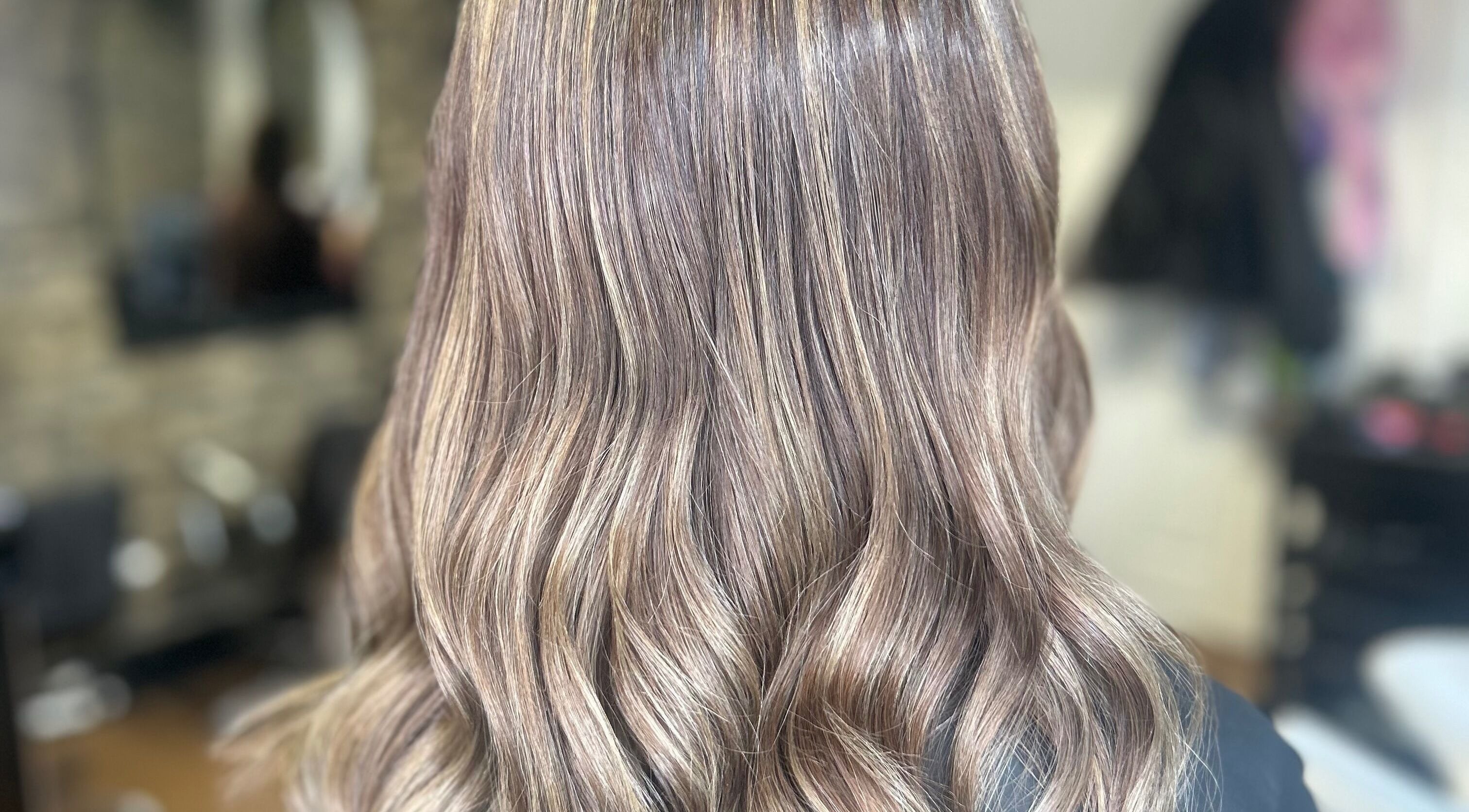 Lustrous wavy hairstyle by Hair by Miya Lock in Neath, Wales, GB, showcasing natural highlights.