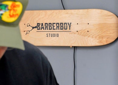 Barber Boy Studio signboard on wooden panel in Horsham, England, GB.