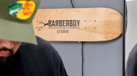 Barber Boy Studio signboard on wooden panel in Horsham, England, GB.