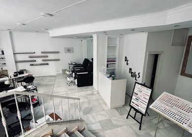 Interior of 27 De Nails, a chic nail salon in Marbella, Andalucía, ES with modern decor and nail polish displays.