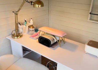 Cozy nail treatment corner at Belle Lily Beauty, Aspley Guise, England, GB, featuring a stylish lamp and equipment.