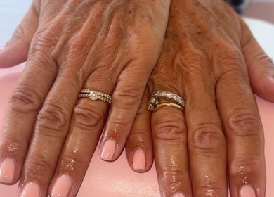 Elegant pink-manicured hands with rings at Belle Lily Beauty, Aspley Guise, England, GB.