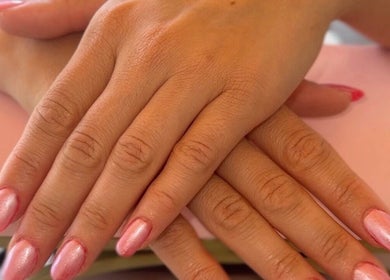Manicured hands with pink polish at Belle Lily Beauty in Aspley Guise, England, GB.