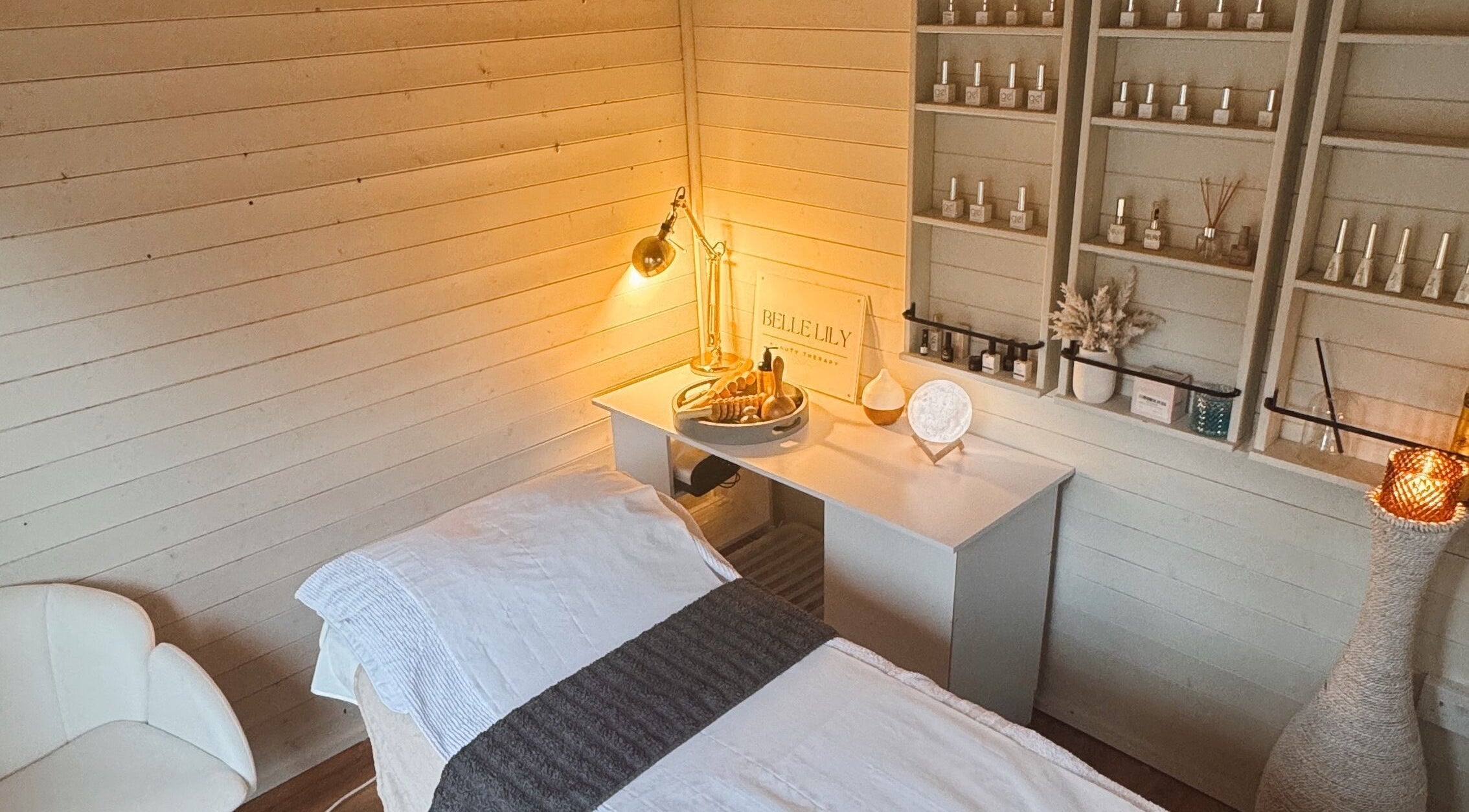 Relaxing treatment room at Belle Lily Beauty, Aspley Guise, England, showcasing serene spa ambiance and decor.