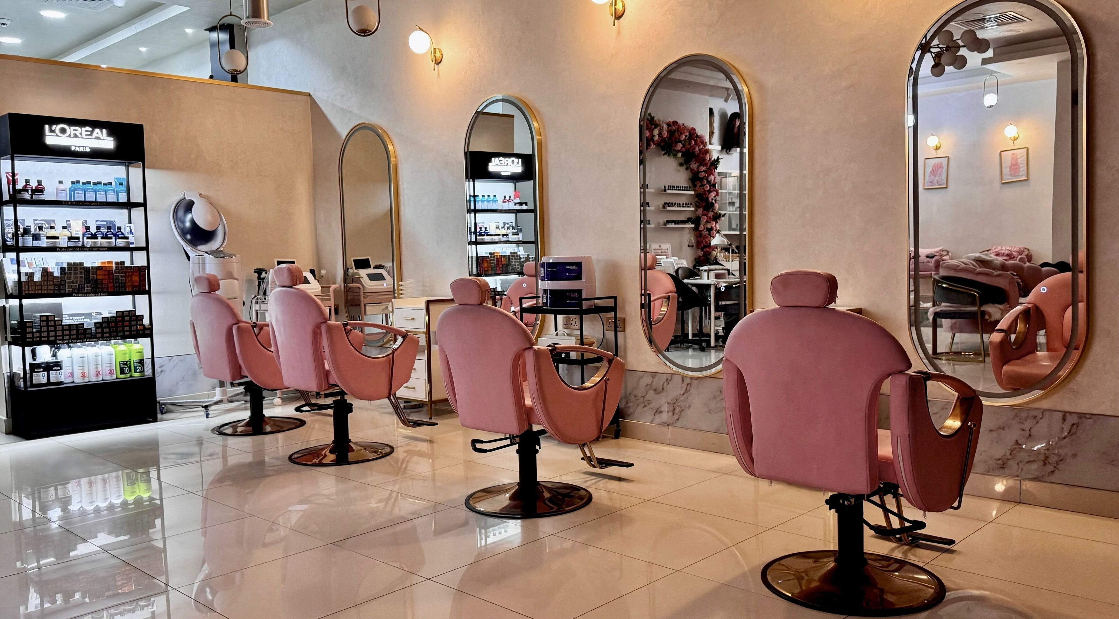 Dorsa Beauty Lounge interior with stylish pink chairs and mirrors, located in Dubai, Dubai, AE.