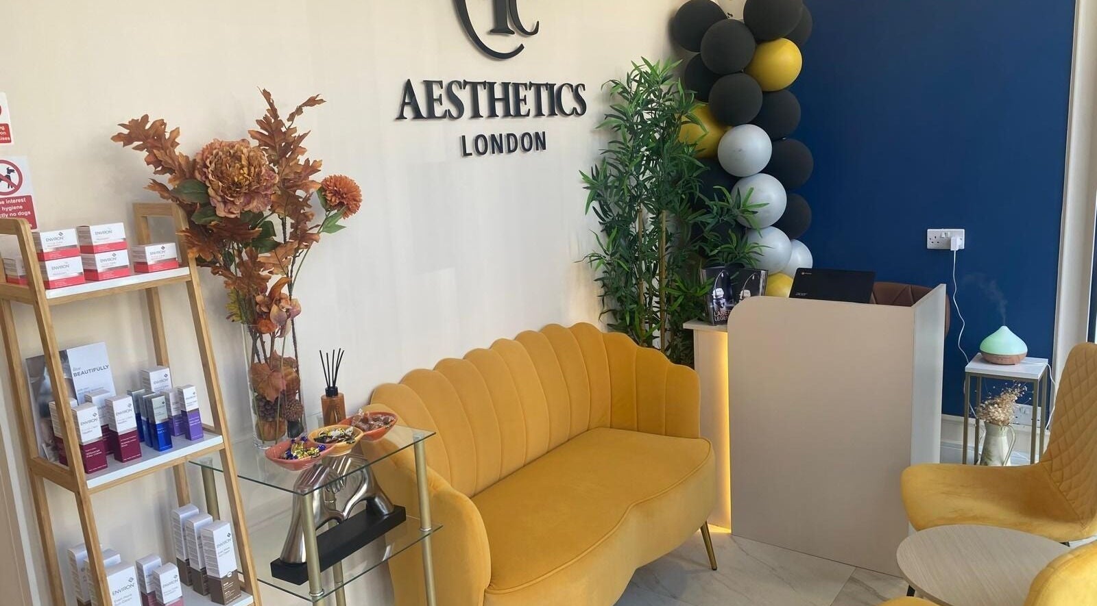 Cozy reception area at EverYoung Medical Aesthetics Clinic, London, England, GB with yellow sofas and decor.