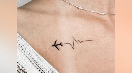 Unique airplane and heartbeat tattoo at Vault Tattoo in Harleysville, Pennsylvania, US.