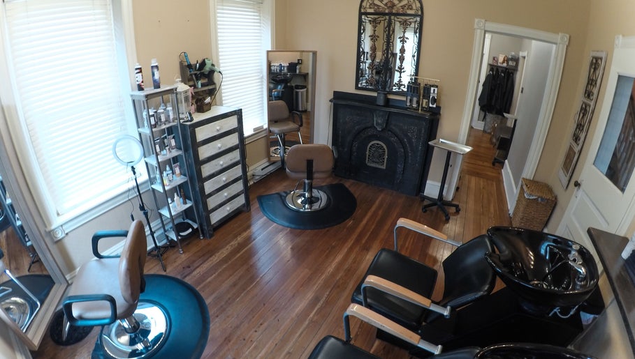 Elegant salon interior at Prodigo Day Spa & Salon, Harleysville, Pennsylvania, with stylist chairs and a fireplace.