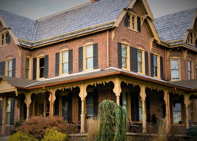 Victorian-style brick building of Prodigo Day Spa & Salon / Vault Tattoo in Harleysville, Pennsylvania, US.
