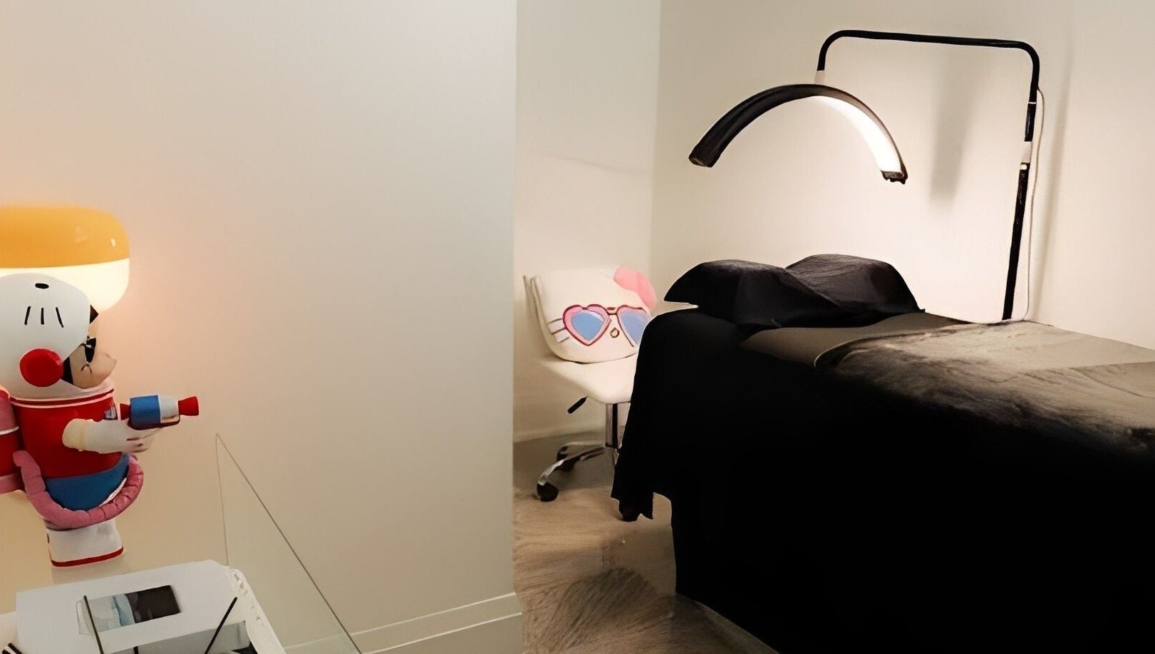 A treatment room at DAZEDEBEAU with a sleek bed and playful decor in Vaughan, Ontario, CA.