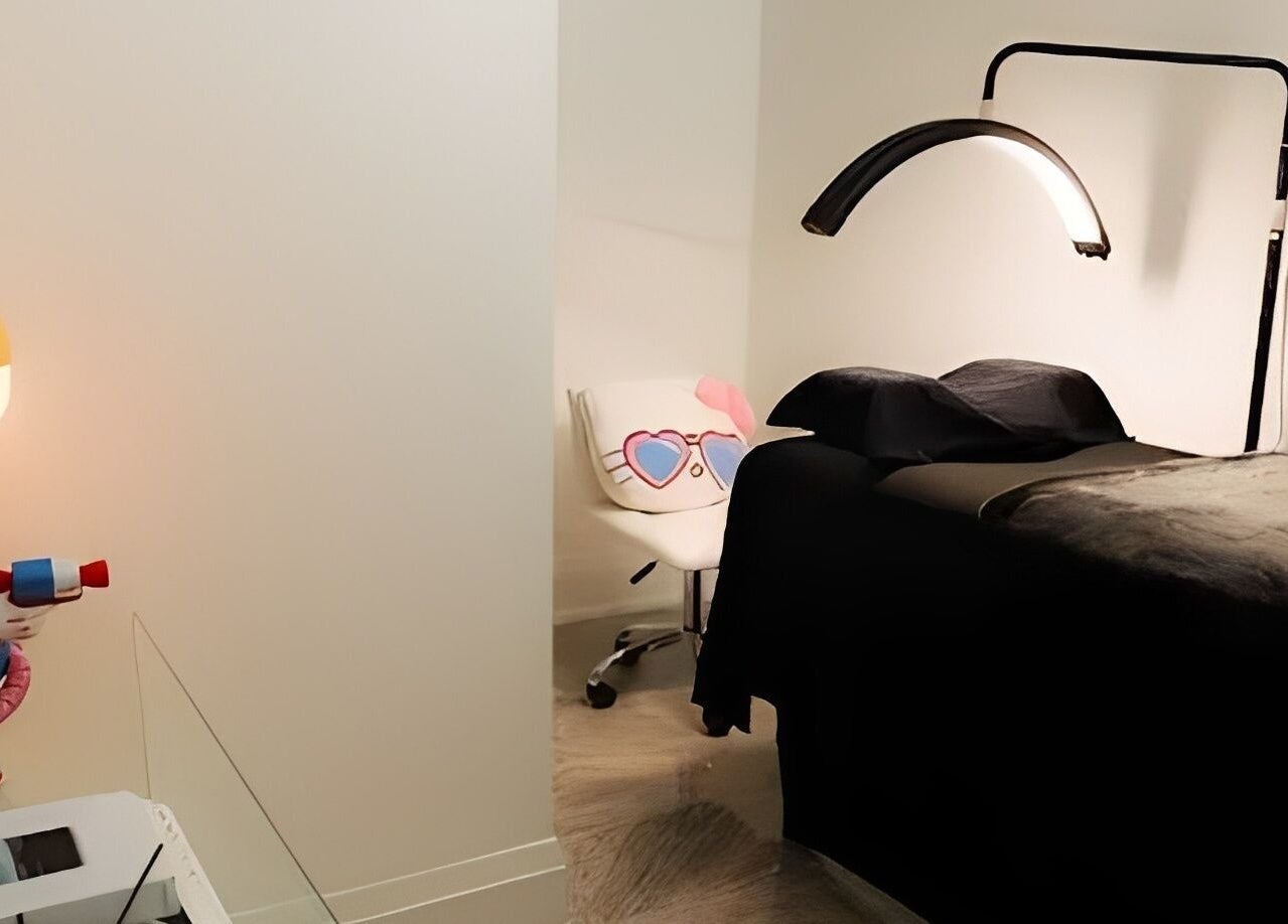 A treatment room at DAZEDEBEAU with a sleek bed and playful decor in Vaughan, Ontario, CA.