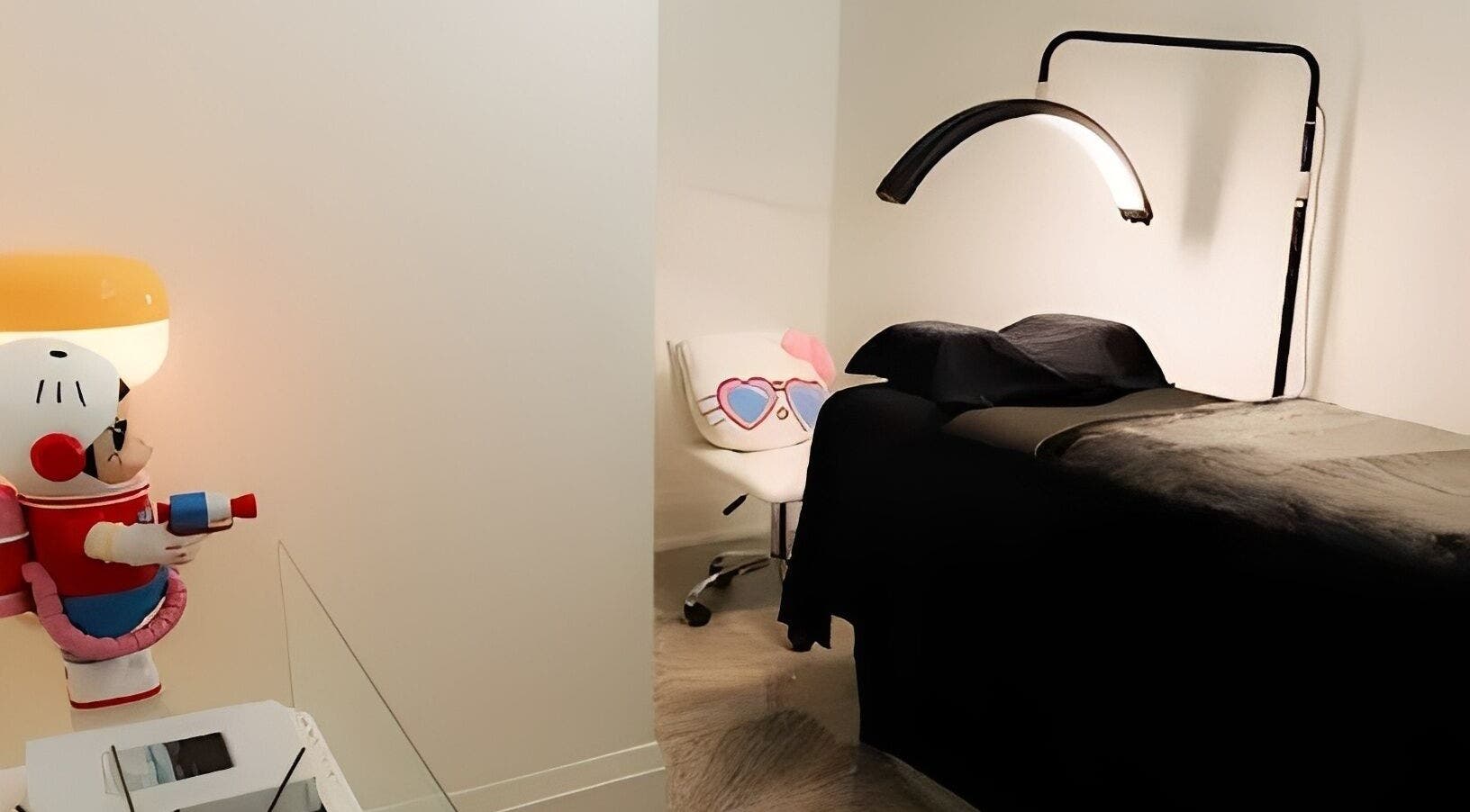 A treatment room at DAZEDEBEAU with a sleek bed and playful decor in Vaughan, Ontario, CA.