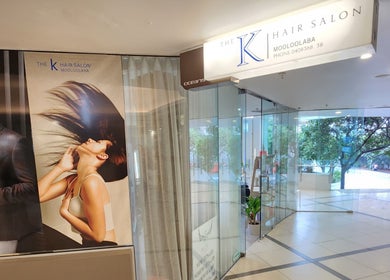 Entrance of THE K HAIR SALON MOOLOOLABA at sunshine coast, Queensland, AU with stylish posters.