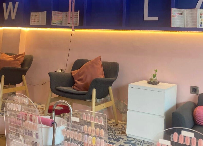 Cozy nail lounge at Sugarbombwax Bali, Bali, ID, showcasing comfortable seating and colorful nail palette displays.