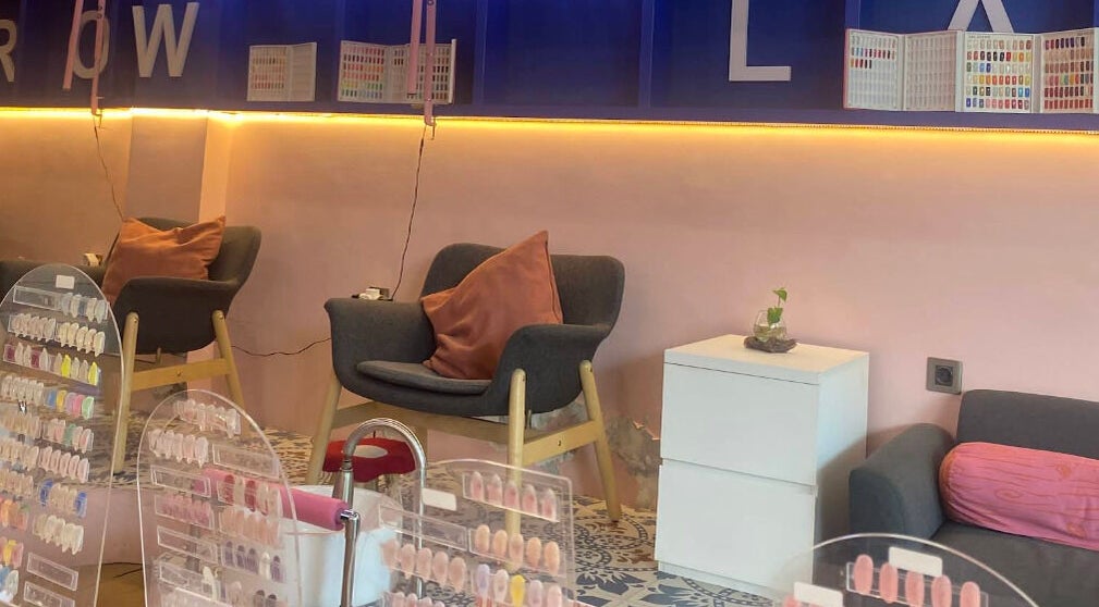 Cozy nail lounge at Sugarbombwax Bali, Bali, ID, showcasing comfortable seating and colorful nail palette displays.