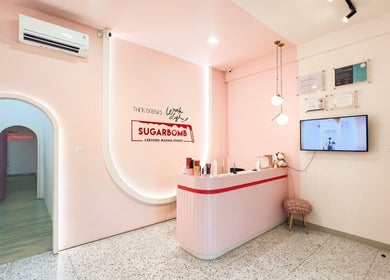 Interior of Sugarbombwax Medan in Sumatera Utara, ID showcasing a stylish pink reception area.