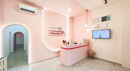 Interior of Sugarbombwax Medan in Sumatera Utara, ID showcasing a stylish pink reception area.
