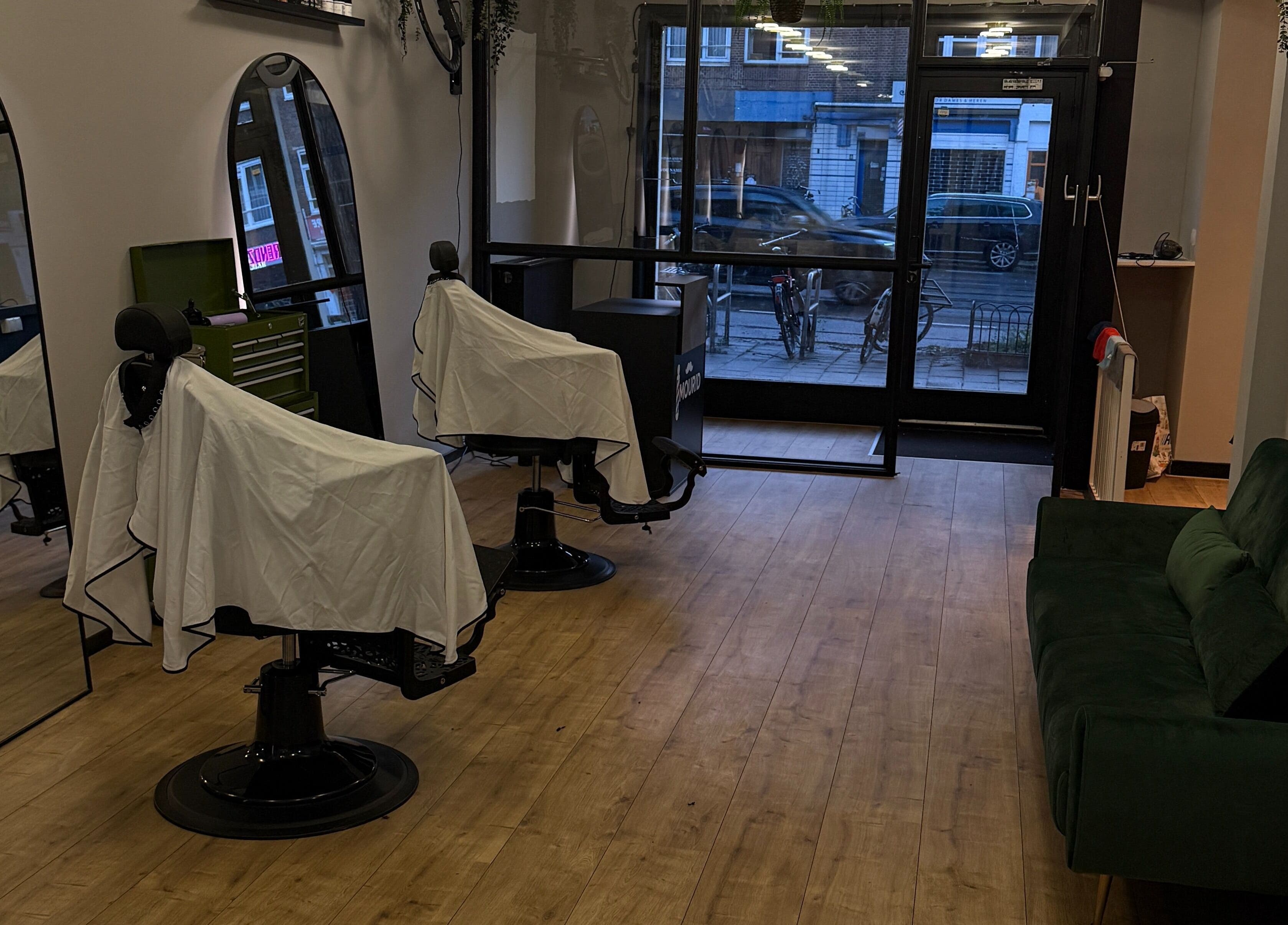 Modern barber chairs at Mourid Zuid, Amsterdam, Noord-Holland, NL, offering a sleek and inviting atmosphere.