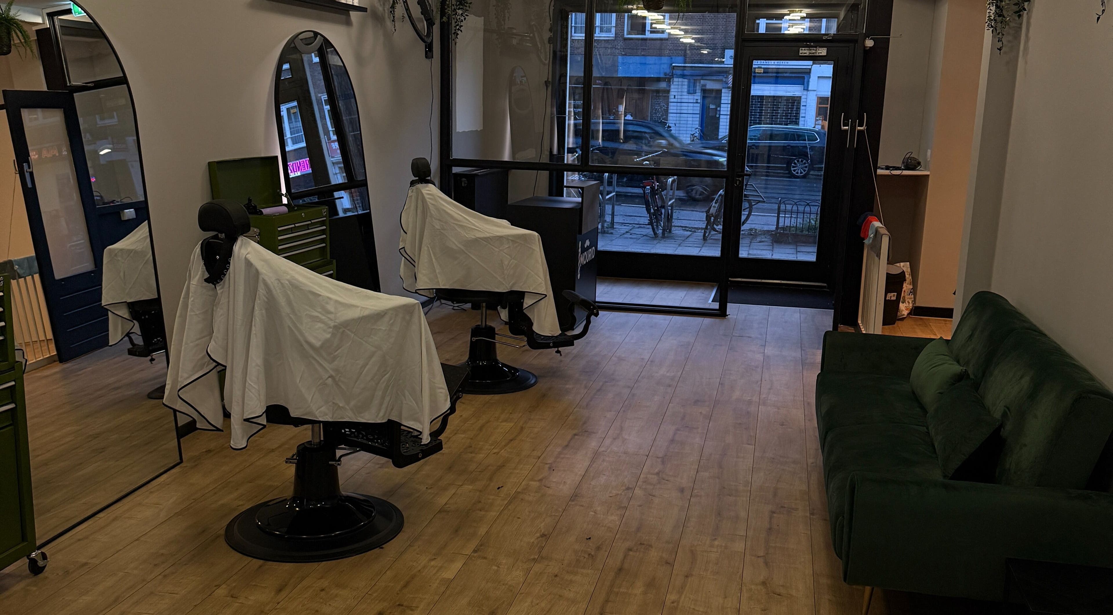 Modern barber chairs at Mourid Zuid, Amsterdam, Noord-Holland, NL, offering a sleek and inviting atmosphere.