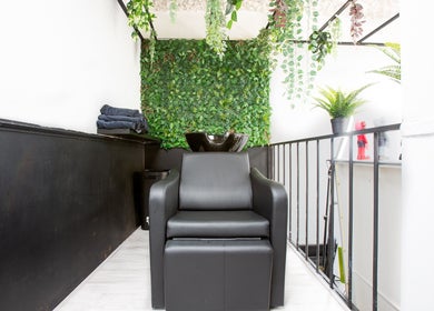 Modern shampoo station at Mourid West, Amsterdam, Noord-Holland, NL with lush greenery and sleek seating.