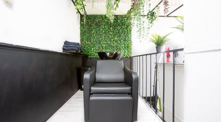 Modern shampoo station at Mourid West, Amsterdam, Noord-Holland, NL with lush greenery and sleek seating.