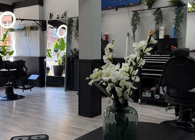 Elegant salon interior at Mourid West, Amsterdam, Noord-Holland, NL with modern decor and stylish barber chair.