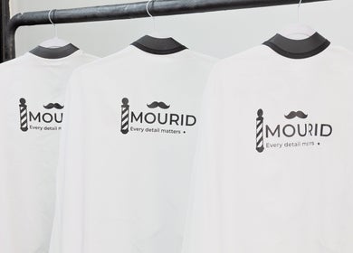 Mourid West branded apparel displayed on hangers at Amsterdam, Noord-Holland, NL.