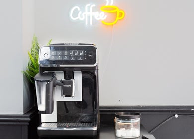 Coffee machine at Mourid West, Amsterdam, Noord-Holland, NL with neon coffee sign and plant.