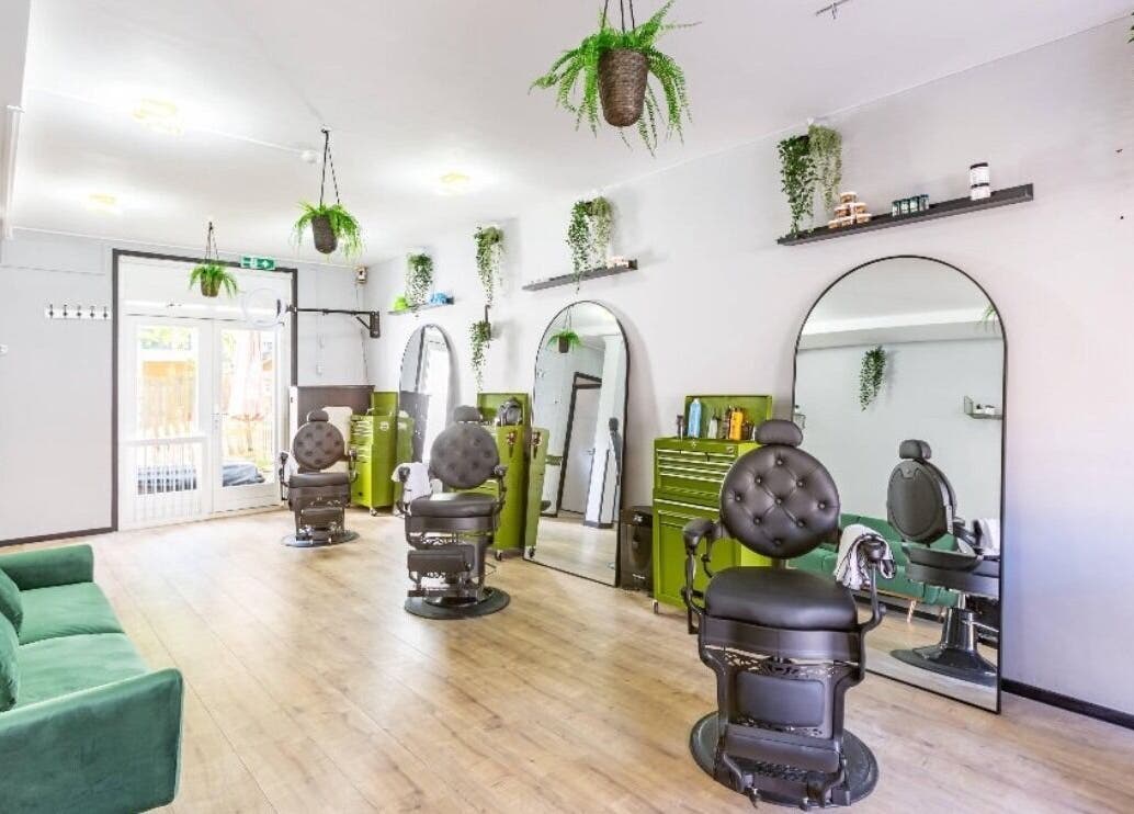 Chic barber chairs and lush greenery at Mourid Zuid, Amsterdam, Noord-Holland, NL.
