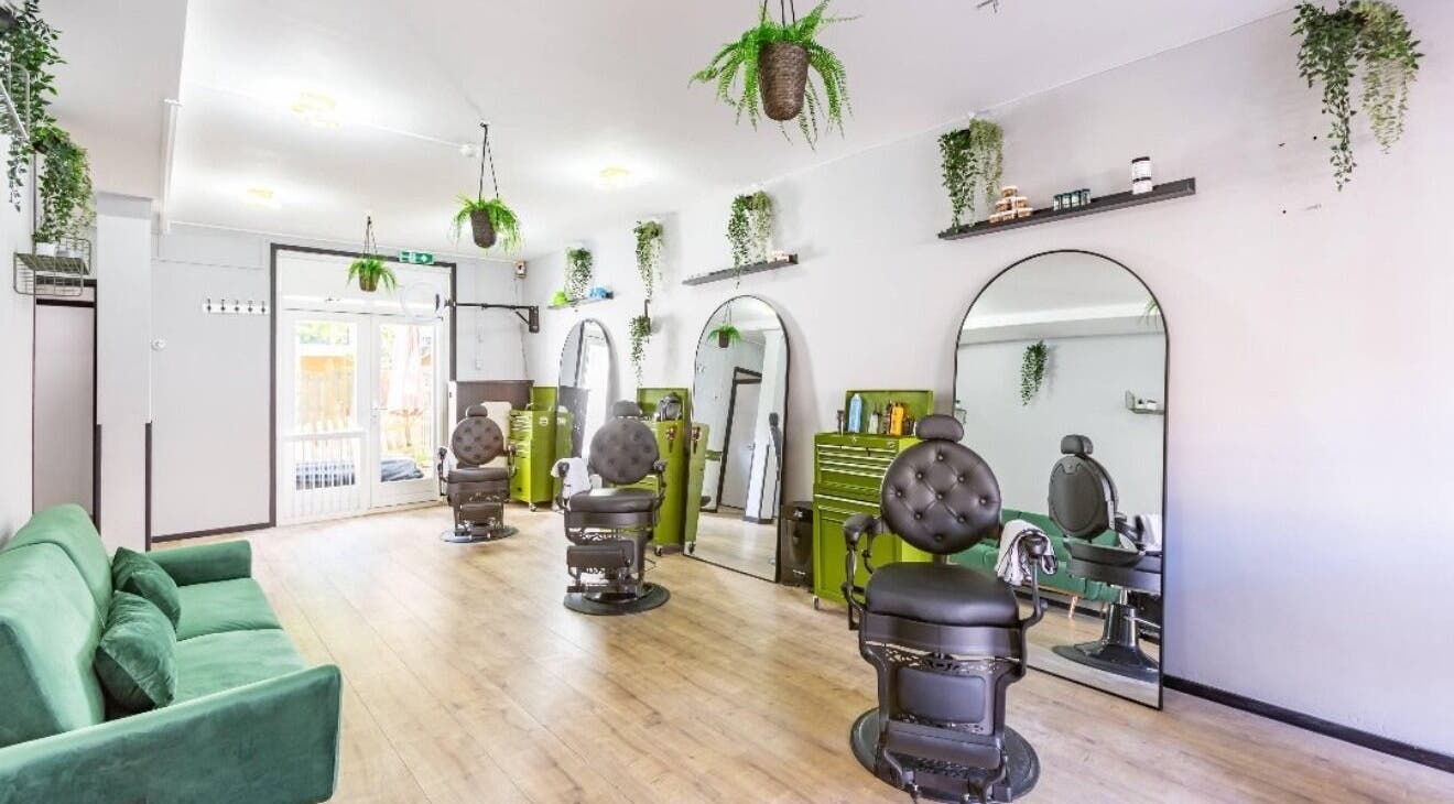 Chic barber chairs and lush greenery at Mourid Zuid, Amsterdam, Noord-Holland, NL.
