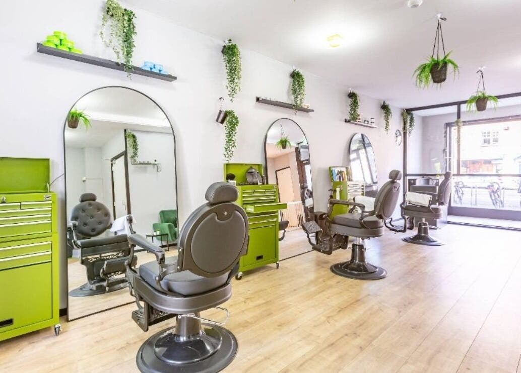 Elegant salon interior of Mourid Zuid with green accents in Amsterdam, Noord-Holland, NL.
