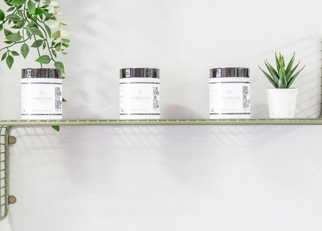 Minimalist shelf with hair products at Mourid Zuid, Amsterdam, Noord-Holland, NL, showcasing green decor.