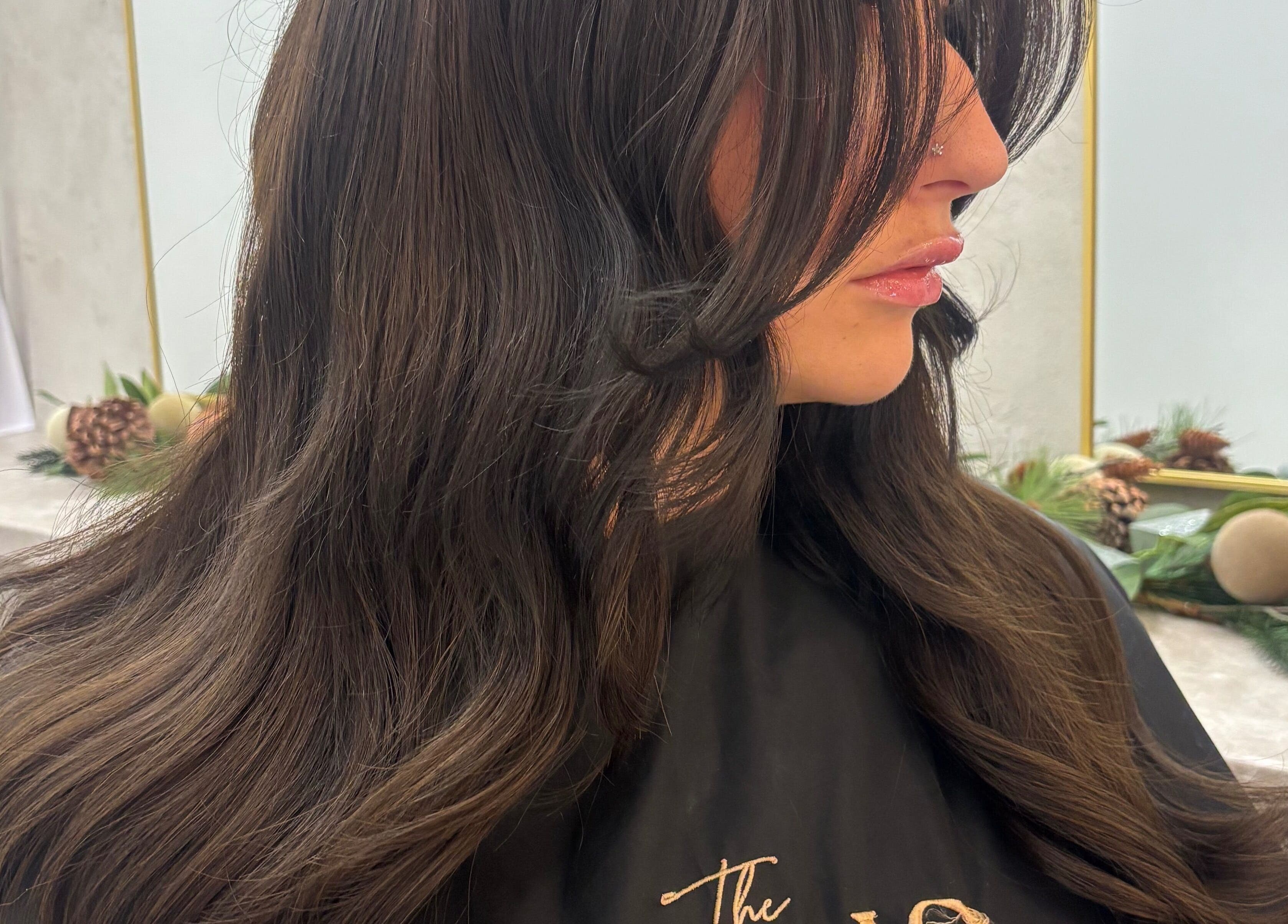 Woman with sleek dark hair styled in voluminous waves at Styled By Eve, Billingham, England, GB.