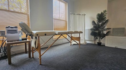 Relaxing massage room at Glow Aura UK, Gravesend, England, GB, featuring a comfortable treatment table.