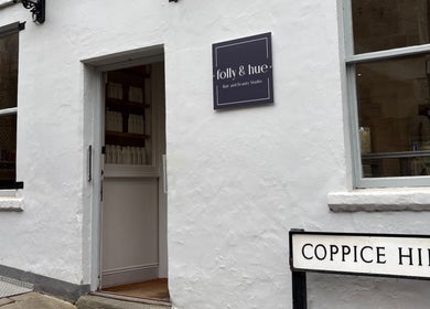 Front of Folly & Hue Hair And Beauty Studio, Bradford-on-avon, England with Coppice Hill sign.