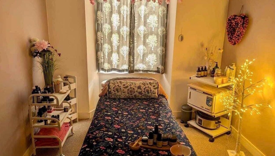 Cozy therapy room at Heavenly Treatments with Hayleybell, Kelso, Scotland, GB with soft lighting and floral decor.